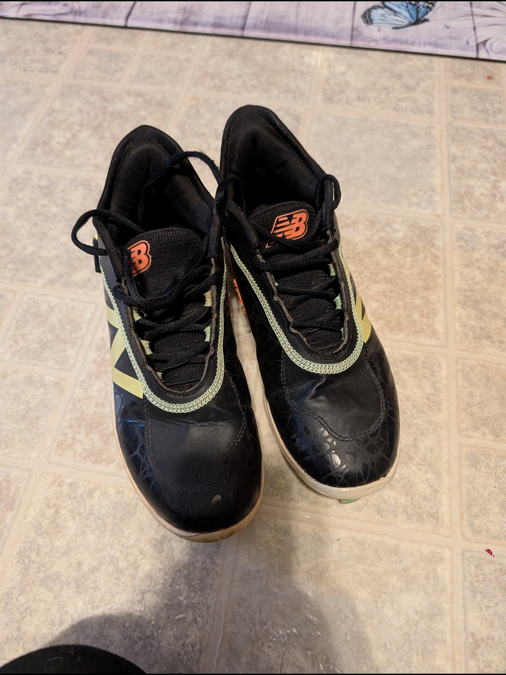 New Balance Black Cleats with Lime Trim and Orange Logo